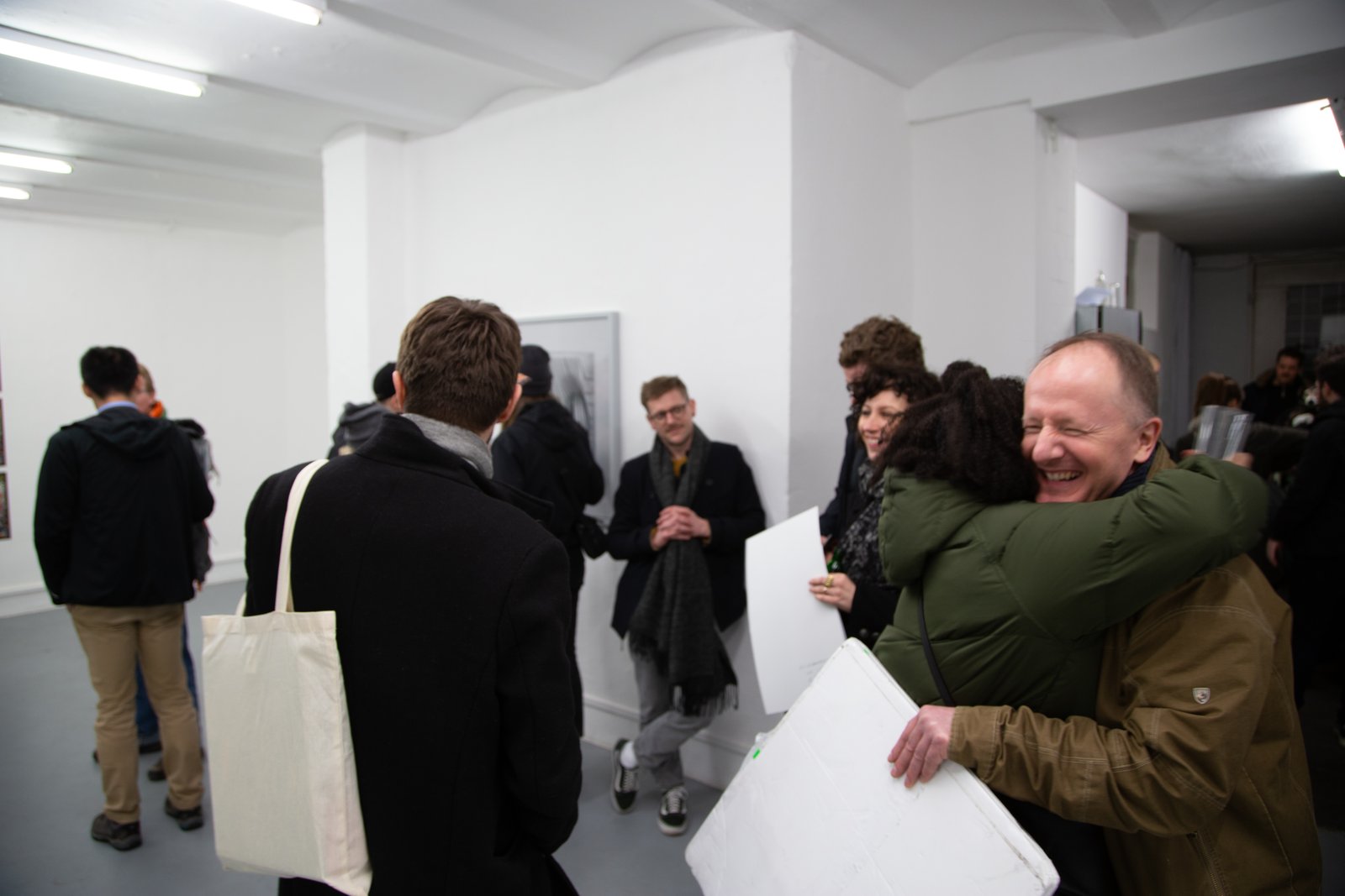 Selling the new project — an embrace at the opening, a sold print carried away